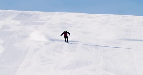 Professional ski video shooting male skier is showing some nice ski turns on a stepp ski slope. Snow