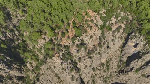 Aerial View Two Friends Strike Poses at the Edge of a Canyon in Turkey