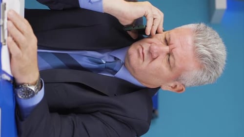Man on Phone Call in Office with Hand Gestures