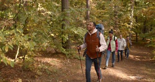 Group of Friends Hiking Together in Autumn Forest