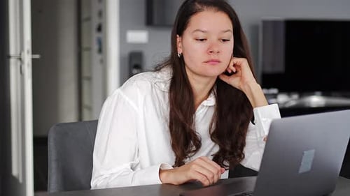 Young Woman Using Laptop at Home Indoors