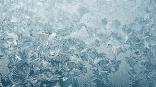 Intricate Ice Crystals Forming on Glass