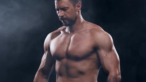 Fitter und sportlicher Bodybuilder auf schwarzem Hintergrund Bodybuilder-Training mit Langhantel Das Konzept von