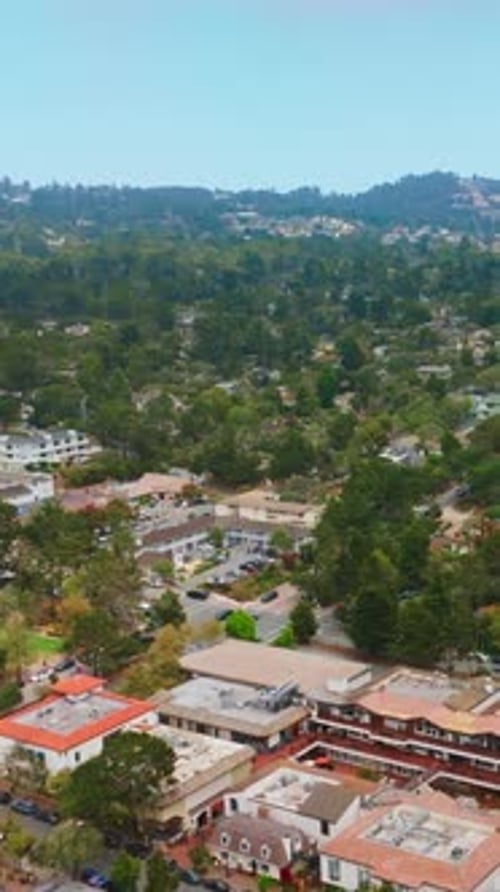 Cozy lovely city of Carmel-by-the-sea in California. Green city panorama with mountains at backdrop