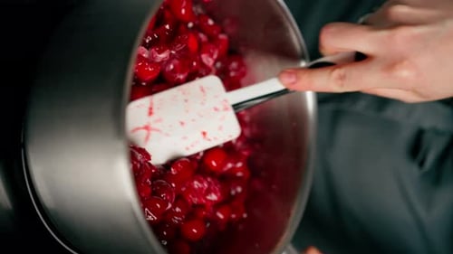 Cooking Bright Red Cherries in a Stainless Steel Pot