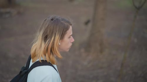 Lone Hiker Strolling Woods Solitary Man with Bag and Beverage White Individual Wandering Through