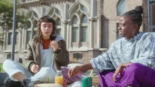 Two Girls Enjoying Picnic on College Campus