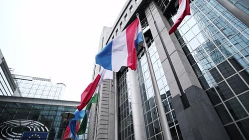 Row Of Eu Member Countries Flags Flying Beside European Parliament Building