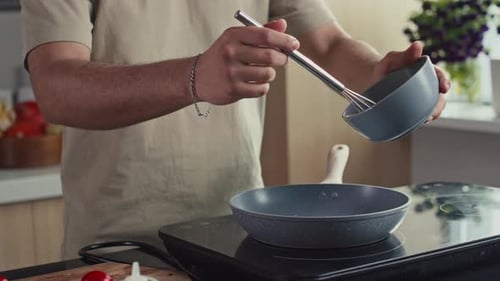 Man Cooking an Omelet in a Kitchen