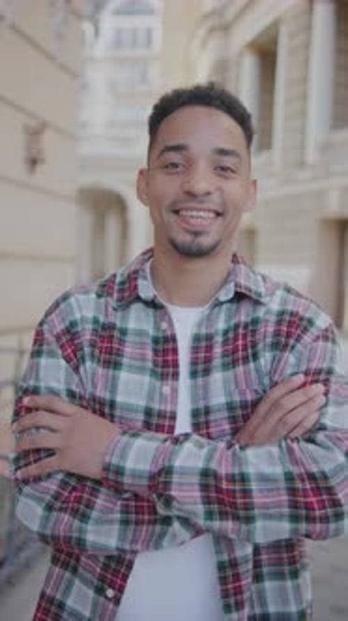 Vertical Portrait of a Young African American Man on the Street A Young Guy Stands on the Street and