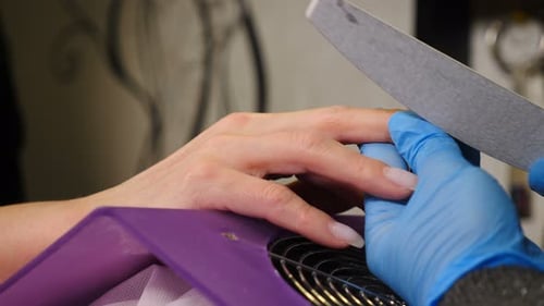 Nail Master in Gloves Makes Professional Manicure in Beauty Salon Closeup Close Up of Professional