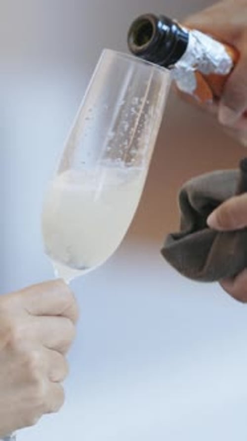 Champagne Being Poured into Champagne Flute in Kitchen