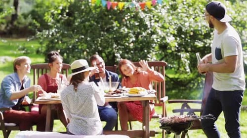 Friends at an outdoor barbecue party in summer