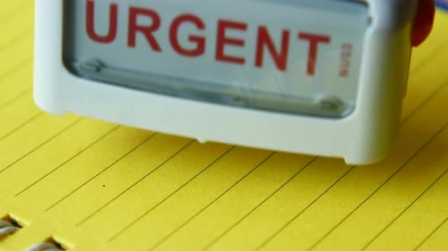 Urgent Stamp on Yellow Lined Paper