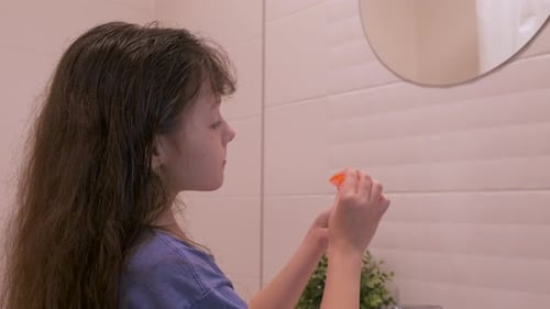 Girl Putting Protective Dental Mouthguard in Mouth
