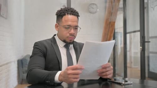 Multiracial Businessman Reading Business Report of Company