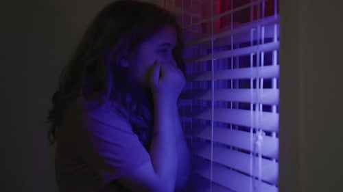 Afraid Child with Scared Face Near Window with Police Siren Scared Kid Hides Silently in Shadow