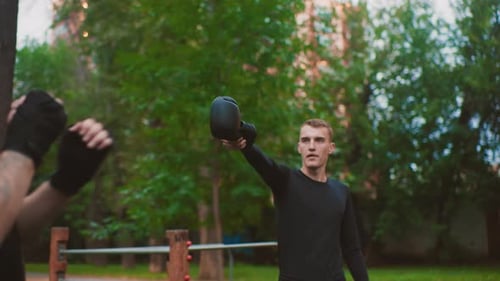 Men Sparring with Boxing Gloves Outdoors