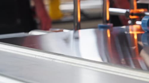 A Pristine Sheet of Beautiful Steel Glides Along the Production Line in the Factory