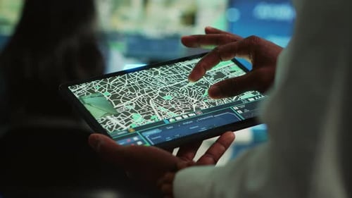 Person Navigating City Map on Digital Tablet