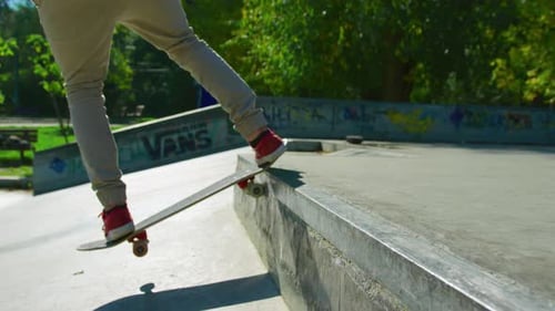 Skateboarder Performing Tricks in Urban Skate Park