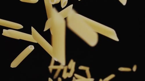 Penne Pasta Flying on a Black Background