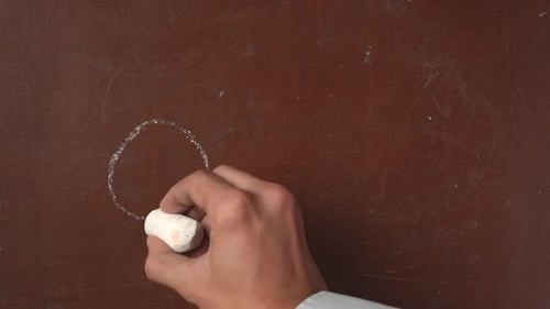 Drawing Gender Symbols on Chalkboard with White Chalk
