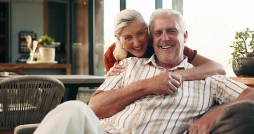 Senior Couple Smiling and Embracing in Modern Home
