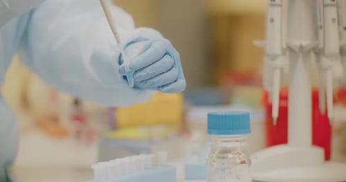 Lab Technician Working With Pipette in Laboratory