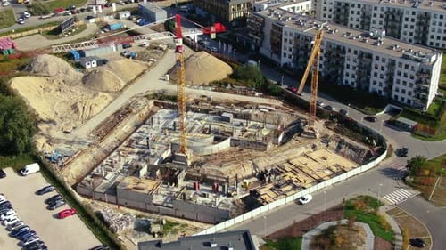 High building construction site. Big industrial tower crane with blue sky amd cityscape on backgroun