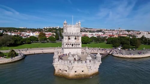Aerial Hyperlapse of Belem Tower in Lisbon, Portugal during a beautiful sunny day next to the river.