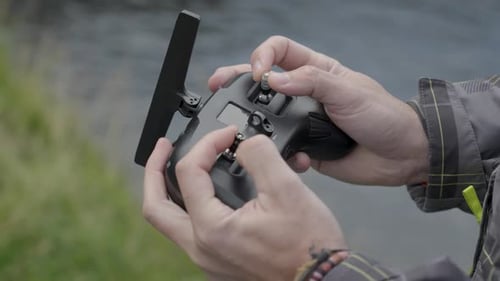 Hands Operating Drone Remote Controller Outdoors