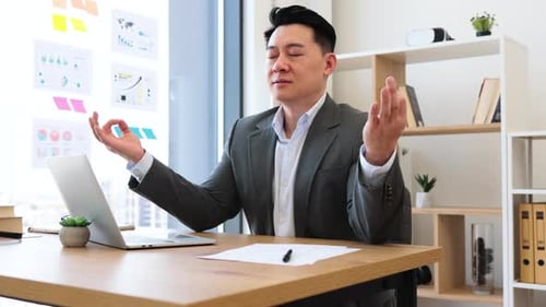 Businessman Practicing Meditation for Stress Relief in Office