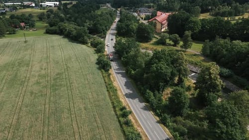 Trucks and cars driving on rural road