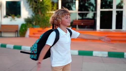 School Student Child with Backpacks Playing Spinning in Yard During Study Break Back to School