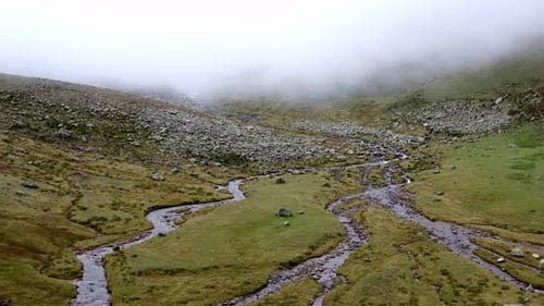 Aerial Flying Upstream In Misty Valley