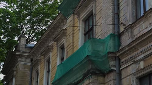 Renovation Work on a Historic Building Recently Covered with Green Netting for Protection During