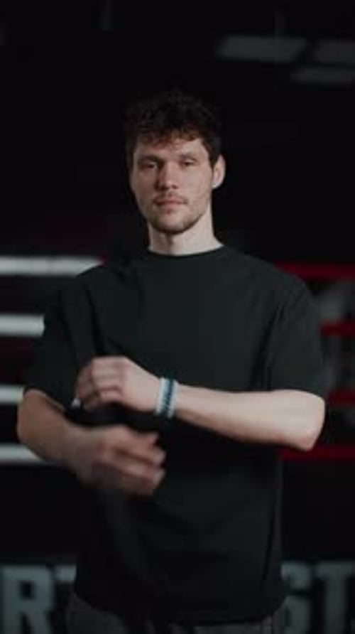 Young Adult Man in Gym with Arms Crossed