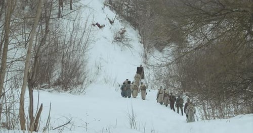 Group Walking Uphill in Snowy Winter Landscape