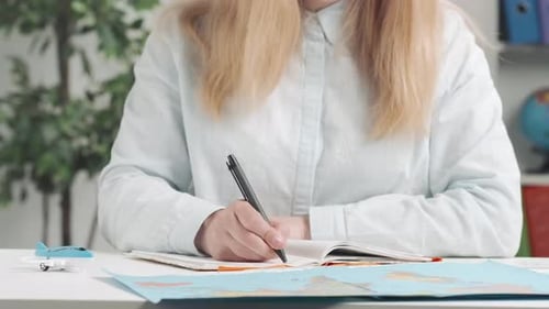 Travel Agent Plans a Trip By Studying a World Map