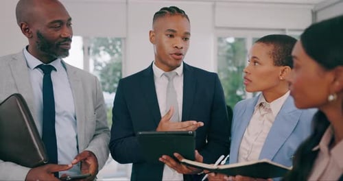 Collaboration, tablet and a business man planning with his team in the office for company growth
