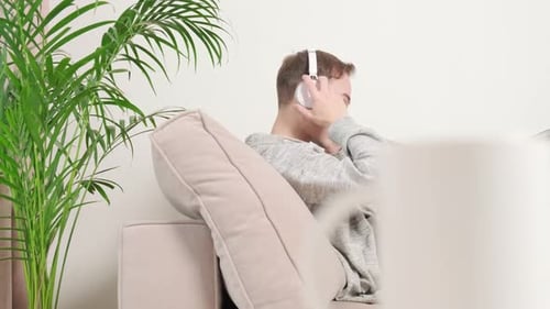 Young Adult Using Laptop Computer on Couch at Home