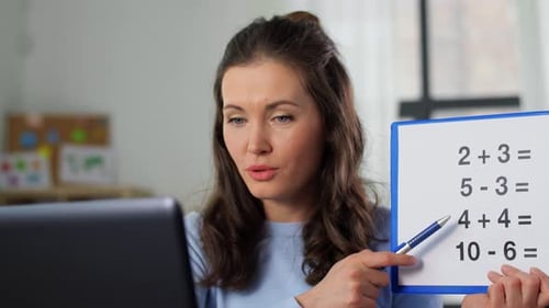 Woman Teaching Online Math with Pen and Board