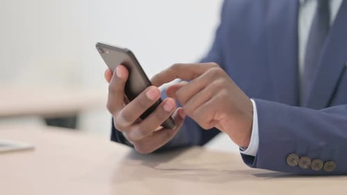 Close up of African Businessman Using Smartphone