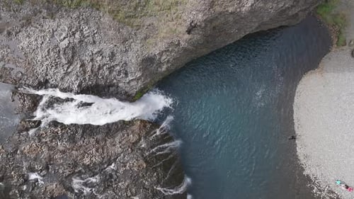 Aerial view of people jumping at Stjornarfoss waterfall, Iceland
