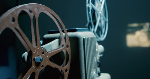 Vintage Film Projector Plays Movie in Dark Room