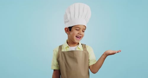 Child, happy face and chef hand to show promotion, advertising or deal in studio
