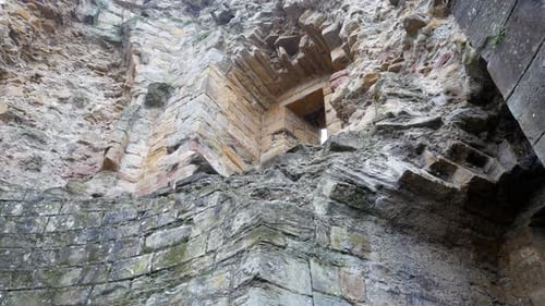 Ancient Basingwerk abbey abandoned historical landmark building stone walls right dolly upward looki