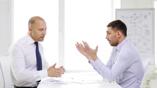 Business, Partnership, Finances and Office Concept - Two Serious Businessmen Holding Papers
