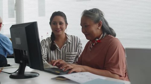 Women Collaborating at a Computer in an Office